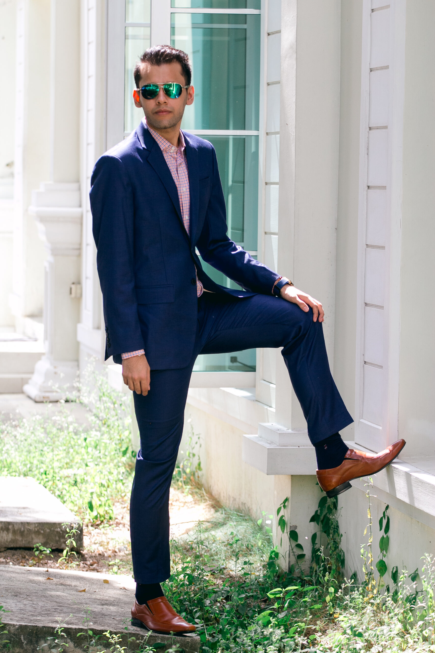 Man in a navy bespoke suit, full body